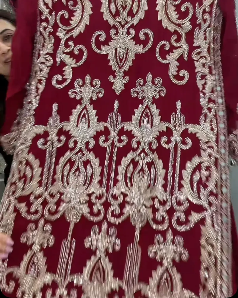 Maroon suit covered in cream and silver embroidery