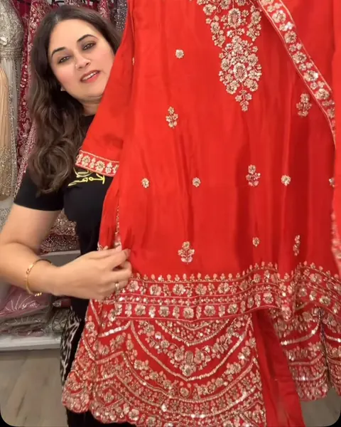 Bright red suit with a gold embroidered hem and dupatta